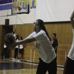 A girl is playing basketball on the court