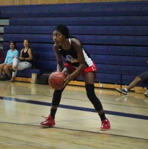 A girl is playing basketball on the court